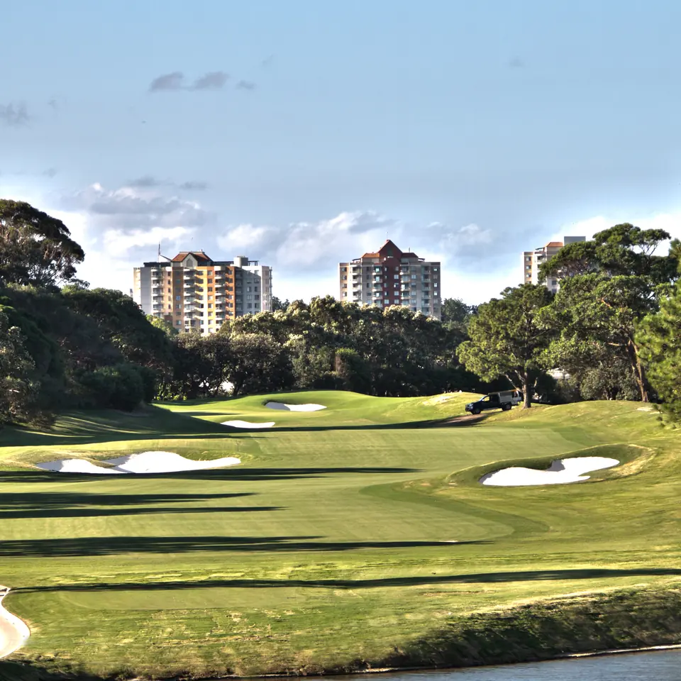 Bunkered fairways at The Australian Golf Club with the Sydney skyline beyond