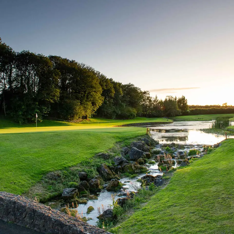 A stone bridge over the stream at Mount Juliet at sunset