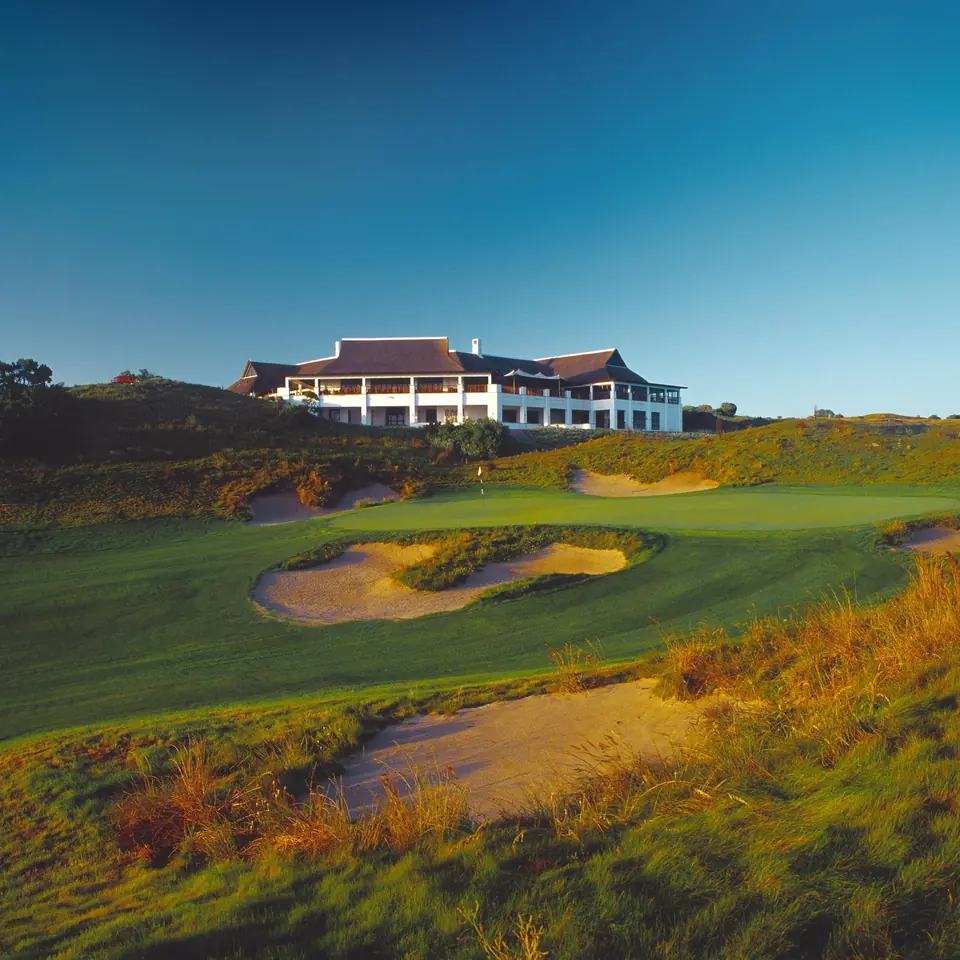 The clubhouse at St Francis Links above a bunkered dune fairway