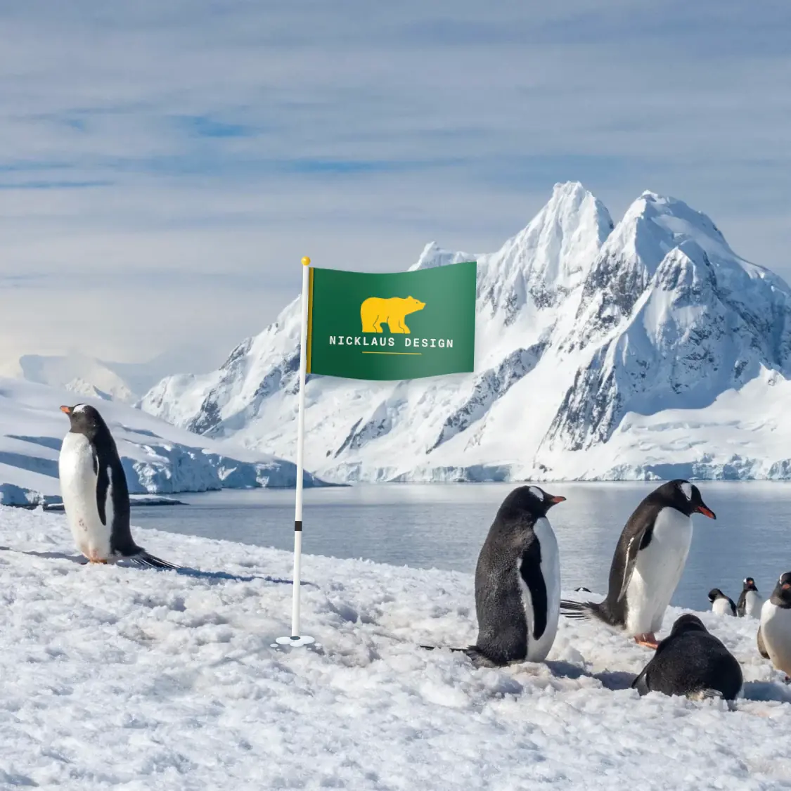 Rendering: a Nicklaus Design flag planted in the Antarctic ice, gentoo penguins and snow peaks behind
