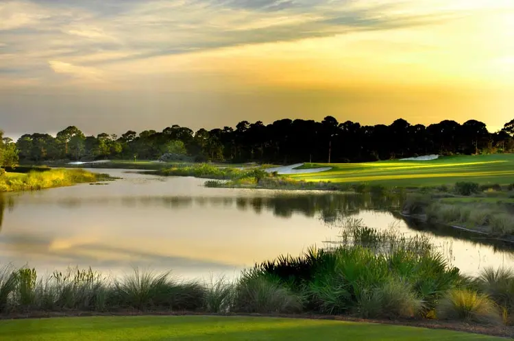 Sunset over the wetlands and a fairway at The Bear’s Club