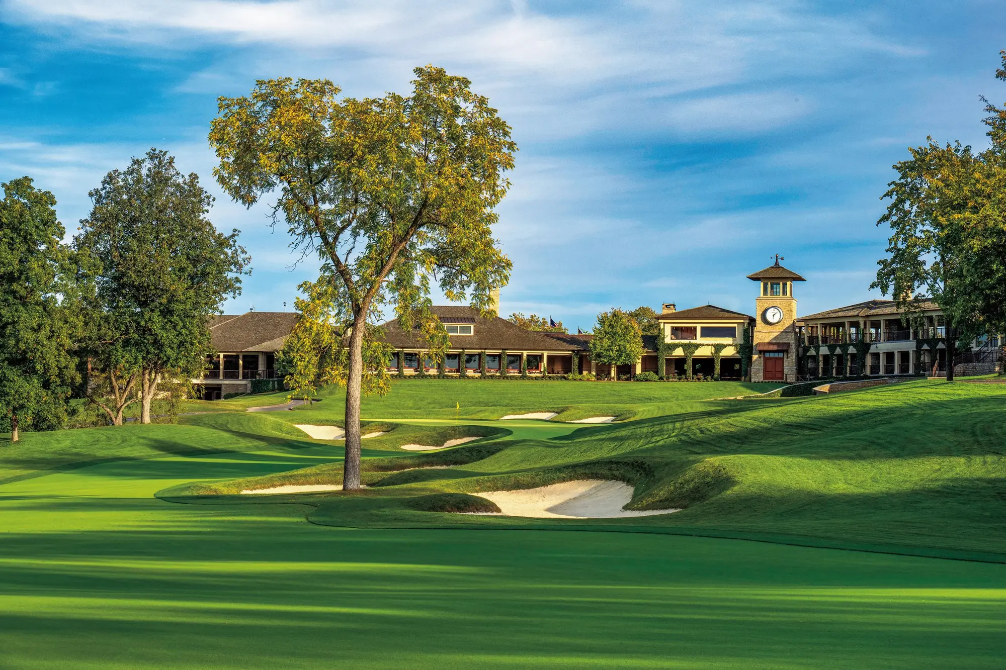 The 18th green at Muirfield Village Golf Club, the clubhouse and its clock tower behind