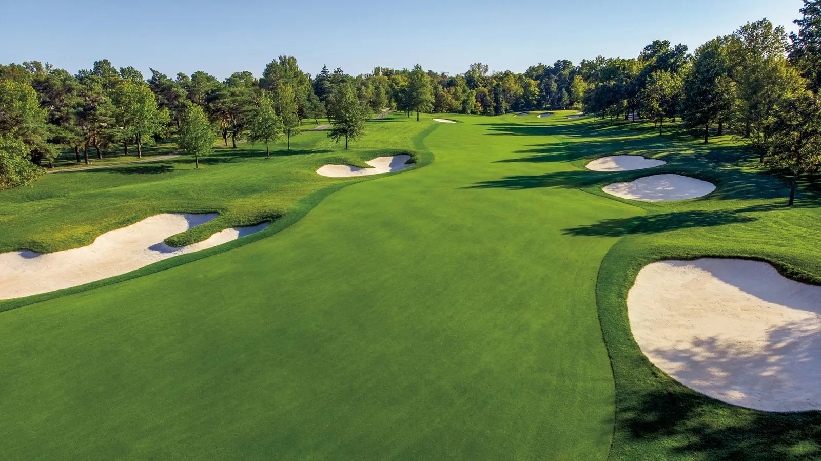 Muirfield Village Golf Club from the air, fairways winding between the trees of Dublin, Ohio
